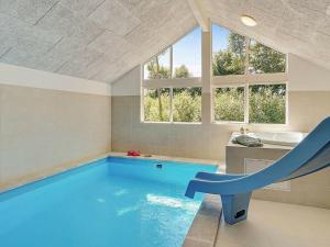 a swimming pool in a bathroom with a slide at 18 person holiday home in Hasselberg in Kappeln