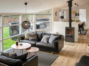 a living room with a couch and a fireplace at 10 person holiday home in Jerup in Jerup