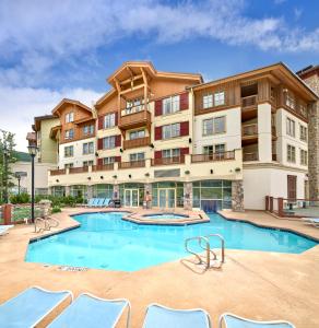 a large apartment building with a large swimming pool at Sun Peaks Grand Hotel & Conference Centre in Sun Peaks