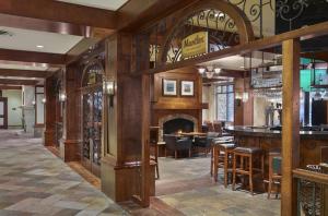 a large room with a bar and a fireplace at Sun Peaks Grand Hotel & Conference Centre in Sun Peaks