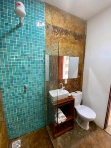 a bathroom with a toilet and a glass shower at Bambo Villa in Paracuru