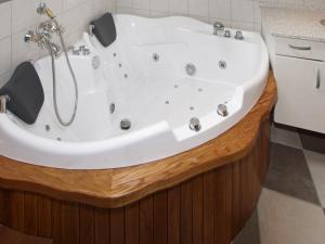 a white bath tub in a bathroom at 8 person holiday home in Hemmet in Hemmet