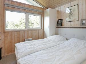 a bedroom with a white bed and a window at 4 person holiday home in Skagen in Skagen