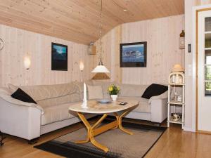 a living room with two couches and a table at 6 person holiday home in Hemmet in Falen