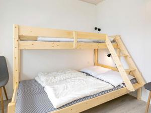 a bunk bed with a ladder on top of it at 12 person holiday home in Vestervig-By Traum in Vestervig