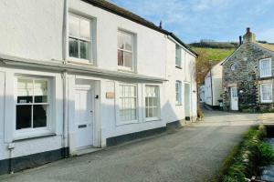 a row of white houses on a street at Leatside Cottage in Port Isaac