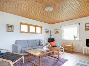 a living room with a couch and a table at 4 person holiday home in Frändefors in Stora Lövnäs