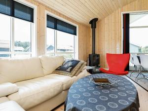 a living room with a couch and a table at 6 person holiday home in Ulfborg in Fjand Gårde