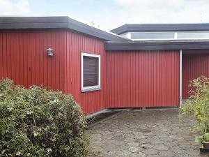 a red building with a window on the side of it at 30 person holiday home in Nordborg in Nordborg