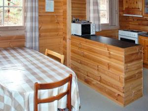 a kitchen with a bed and a counter with a microwave at 5 person holiday home in VÅGLAND in Bårdset +45 photos