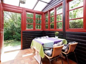 a screened in porch with a table and chairs at 6 person holiday home in Gilleleje in Gilleleje