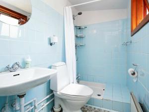 a blue bathroom with a toilet and a sink at 6 person holiday home in Gilleleje in Gilleleje