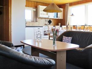 a living room with a table and a kitchen at 8 person holiday home in Harbo re in Vrist