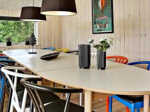 a dining room with a white table and chairs at 14 person holiday home in Stege in Stege