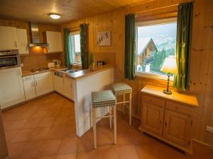 a kitchen with a counter and chairs in a room at Chalet in Annaberg-Lungötz with a community pool in Annaberg im Lammertal