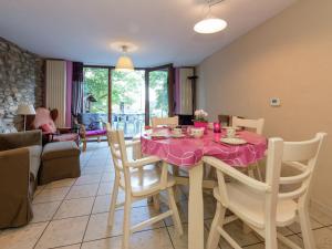 a dining room with a pink table and chairs at Spacious holiday home in Vielsalm with garden in Vielsalm