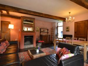 a living room with a couch and a fireplace at Enchanting Cottage with Terrace Garden in Hamoir