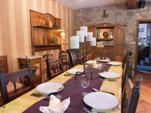 a dining room with a table with plates and glasses at Spacious holiday home in Theux with swimming pool in Desnié
