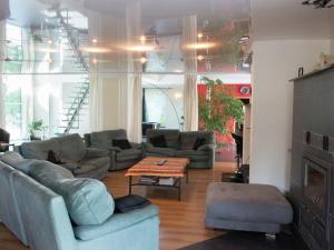 a living room with couches and a table at Beautiful loft in Stoumont with sauna and indoor pool in Stoumont