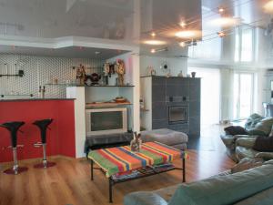 a living room with a couch and a tv and a table at Beautiful loft in Stoumont with sauna and indoor pool in Stoumont