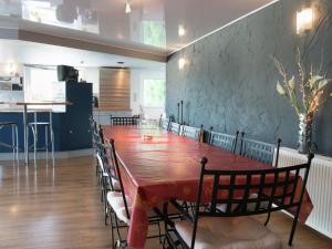 a dining room with a long table and chairs at Beautiful loft in Stoumont with sauna and indoor pool in Stoumont