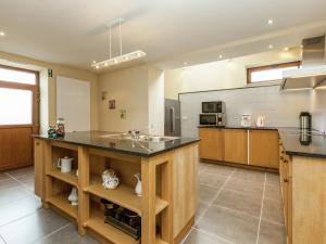 a large kitchen with a sink and a counter at Luxurious Holiday Home in Glabbeek with Garden in Bunsbeek