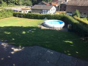 an overhead view of a swimming pool in a yard at A large family house in Stavelot