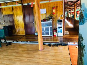 a living room with a table and a refrigerator at Trần Thực homestay-Ba bể in Ba Be18