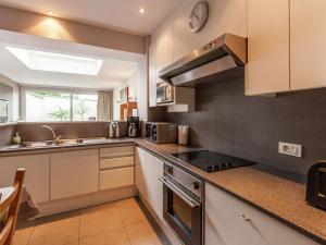 a kitchen with a sink and a stove top oven at Renovated city house in Kortrijk