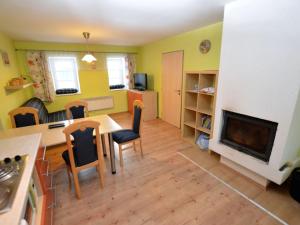 a living room with a table and a fireplace at Comfy Holiday Home near Forest in Medenec in Měděnec