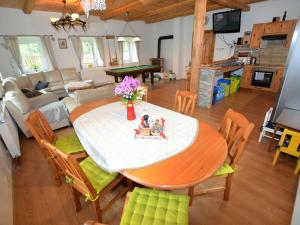 a living room with a table with two dolls on it at Comfortable holiday home with sauna and billiards ski slope 2 km in Rudolfov