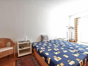 a bedroom with a bed and a chair and a window at Lovely Apartment in Plau am See Germany near Plauer Lake in Plau am See
