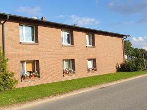 a brick house with flower boxes on the windows at Pleasant Apartment in Kropelin With Terrace in Kröpelin