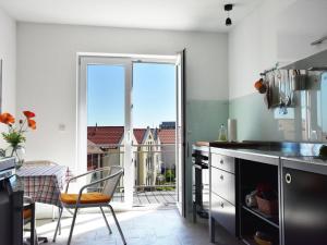 a kitchen with a view of a balcony at Exklusive Panoramawohnung in Barth in Barth +32 photos