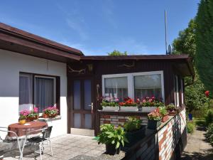 a house with potted plants on a patio at Bungalow in Kühlungsborn-West in Kühlungsborn