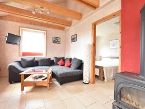 a living room with a couch and a fireplace at Enchanting Holiday Home in Ruhn near the Sea in Rühn