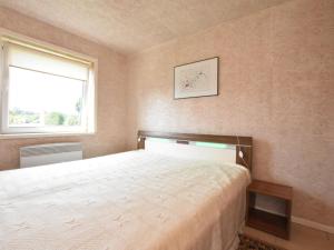 a bedroom with a bed and a window at Enchanting Holiday Home in Ruhn near the Sea in Rühn