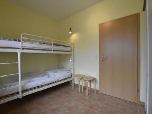 a room with two bunk beds and a door at Relaxed Apartment in Puerto del Carmen with Swimming Pool in Zierow