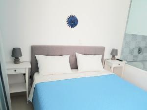 A bed or beds in a room at White & Blue