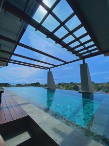 a swimming pool with a view of the water at Kayangan Boutique Hotel in Sanur