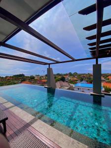 a pool on the roof of a house at Kayangan Boutique Hotel in Sanur