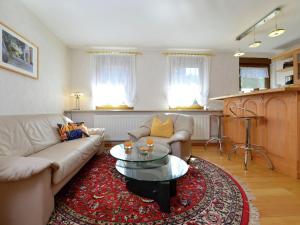 a living room with a couch and a coffee table at Inviting Apartment in Eimelrod with Garden in Willingen