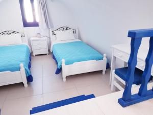 A bed or beds in a room at White & Blue