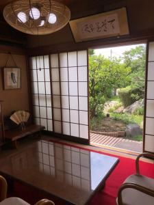 a room with a window with a view of a garden at Sakura house in Kyoto