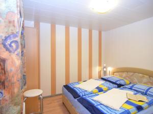 a bedroom with a bed with a striped wall at Holiday home in Wernigerode with private garden in Wernigerode