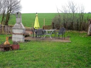 a table and chairs and an umbrella in a yard at Pleasant Apartment in Kierspe with Private Terrace in Kierspe