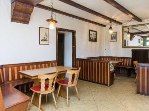a dining room with a wooden table and chairs at Large group house beautifully located in Eifel in Ammeldingen