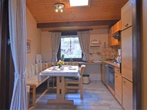 a kitchen with a table and a dining room at Furnished Bungalow With Peaceful Neighbourhood in Meschede