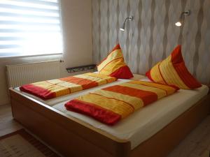 two beds with colorful blankets and pillows on them at Apartment with private terrace in Runkel in Ennerich