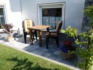 a table and two chairs sitting on a patio at Apartment with private terrace in Runkel in Ennerich